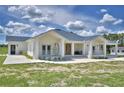 Stunning home showcasing a charming porch with modern railing, inviting entryway, and ample outdoor space at 359 Terminal Ave, Polk City, FL 33868
