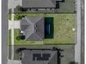 Aerial view of a home with fenced in backyard, well maintained landscaping, and a large driveway at 5660 Elsinore Way, Lakeland, FL 33805