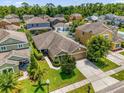 Aerial view of a single Gathering home in a residential neighborhood with mature trees and lush lawns at 1111 Bassano Way, Orlando, FL 32828