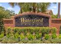 Waterford Trails brick community sign surrounded by lush landscaping at 1111 Bassano Way, Orlando, FL 32828