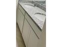 Elegant bathroom vanity with dual sinks, granite countertop, and white cabinetry at 5543 Siltstone St, Lakeland, FL 33811