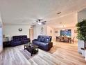 Spacious living room featuring modern furnishings, wood-look flooring, and ample natural light at 5790 Cherry Tree Dr, Lakeland, FL 33811