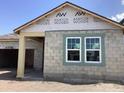 New construction home with concrete block exterior and visible framing and windows at 5722 Cattle Ranch Drive, St Cloud, FL 34771