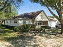 Charming ranch home featuring a brick facade, attached garage, manicured landscaping, and well-maintained lawn at 9859 Sw 97Th St, Ocala, FL 34481