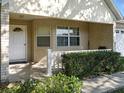 Charming front porch with brick columns and manicured landscaping, creating a welcoming curb appeal at 9859 Sw 97Th St, Ocala, FL 34481