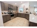Well-equipped kitchen featuring stainless steel appliances, granite countertops, and ample cabinetry at 10274 Julia Isles Ave, Oxford, FL 34484