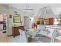 Bright dining room with chandelier lighting and vaulted ceilings at 523 Club Cir, Lakeshore, FL 33854