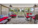 Spacious sunroom with tile floor and ample seating with a beautiful backyard view at 523 Club Cir, Lakeshore, FL 33854