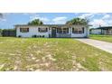 Attractive single-story home with a covered front porch and a well-manicured front lawn at 811 Casselberry Dr, Lake Wales, FL 33853