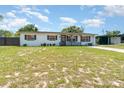 Pleasant home with a tidy lawn, charming porch, and a serene neighborhood ambiance at 811 Casselberry Dr, Lake Wales, FL 33853