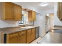Bright kitchen featuring wooden cabinets, a white refrigerator, and a sink overlooking the dining area at 1440 12Th St, Clermont, FL 34711