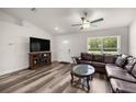 Cozy living room with a leather sectional sofa, decorative coffee table, and lots of natural light at 231 Marion Oaks Trl, Ocala, FL 34473