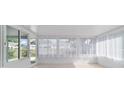Bright sunroom with tile floor and white sheer curtains at 8851 Sw 116Th Street Rd, Ocala, FL 34481