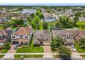 Lovely aerial view of a home in a Gathering-friendly neighborhood featuring mature trees and a community lake at 1138 Fountain Coin Loop, Orlando, FL 32828