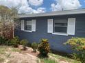 The home features a well maintained gray brick exterior with white shutters and neat landscaping at 119 Allen Ave, Winter Haven, FL 33880