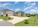 Lovely two-story home with well-kept lawn and landscaping in a Gathering-friendly neighborhood at 1518 Louise Ave, Auburndale, FL 33823