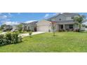 A well-manicured lawn and landscaping complement this lovely two-story home at 1518 Louise Ave, Auburndale, FL 33823