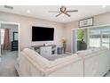 Cozy living room featuring a plush sectional sofa, large TV, and sliding glass doors at 1518 Louise Ave, Auburndale, FL 33823