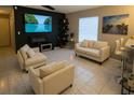 Modern living room with tile floors, a large screen tv, and comfortable seating at 528 Winding Oak Ln, Longwood, FL 32750