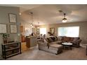 Inviting living room with cozy seating, neutral decor, and seamless flow to the dining area at 2509 Montecito Ave, Eustis, FL 32726