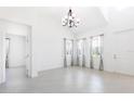 Bright living room with tile floors, large windows, modern lighting, and neutral decor at 198 Gypsy Palace Ln, Daytona Beach, FL 32124
