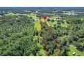 Aerial view showcasing property boundaries, wooded areas, and surrounding landscape at 10222 Rockridge Rd, Lakeland, FL 33810