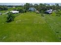 Expansive vacant land with lush greenery and distant houses at 10222 Rockridge Rd, Lakeland, FL 33810
