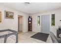 Inviting foyer with tile flooring, a gray door, and access to other living areas at 1149 Shady Cove E Rd, Haines City, FL 33844