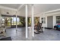 Covered screened-in patio offering scenic lake views and space for relaxing at 1149 Shady Cove E Rd, Haines City, FL 33844