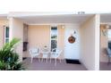 Charming front porch with a welcome wreath and seating area for relaxing at 4733 Club Cir, Lakeshore, FL 33854