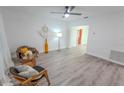 Bright, airy living room features modern ceiling fan and wood-look laminate floors at 1400 E Fern Rd, Lakeland, FL 33801