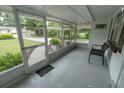 Covered screened porch with seating and neutral epoxy flooring at 1400 E Fern Rd, Lakeland, FL 33801