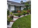 Landscaped front entrance with stone accents and walkway at 7607 Benji Ridge Trl, Kissimmee, FL 34747