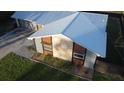 Bird's eye view of the home's blue metal roof, modern stone facade, and meticulously maintained landscaping at 4041 Se 20Th Ct, Ocala, FL 34480