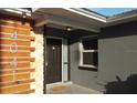 Close up of the front door with stone and wood finishes and modern house numbers at 4041 Se 20Th Ct, Ocala, FL 34480
