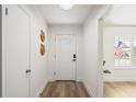 Bright entryway featuring wood-look flooring, a stylish front door, and a sunlit ambiance at 5324 Messina, Lakeland, FL 33813