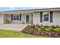 Close up on the entry way of this single Gathering home with beautiful and decorative front yard landscaping at 5324 Messina, Lakeland, FL 33813