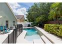Backyard pool with a spa featuring patio furniture, privacy fence, and mature landscaping at 643 Blenheim Loop, Winter Springs, FL 32708