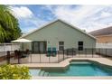 Backyard pool with a black fence, outdoor seating area, and a well-maintained patio at 643 Blenheim Loop, Winter Springs, FL 32708