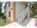 Corner of building showing stairs and an A/C unit, complimented by the well maintained garden at 946 15Th St # 202, Daytona Beach, FL 32117