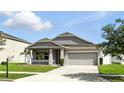 Lovely single-story home with a two-car garage and well manicured lawn at 303 Briarbrook Ln, Haines City, FL 33844