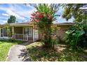 Exterior of property featuring mature landscaping and walkway to entry at 5455 Pinetrail Way, Orlando, FL 32822