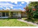 Inviting front exterior featuring a well manicured lawn and vibrant flowers at 5455 Pinetrail Way, Orlando, FL 32822