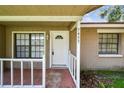 Welcoming covered front porch with classic white trim and brick exterior at 5455 Pinetrail Way, Orlando, FL 32822