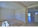 Bright living room with neutral carpet and a view into the dining area with neutral tile flooring at 2005 Carnostie Rd, Winter Haven, FL 33884