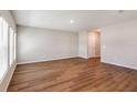 A bright and airy living room with hardwood floors and white trim, illuminated by natural light from the windows at 738 Ambleside Dr, Haines City, FL 33844
