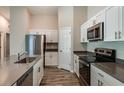 Well-equipped kitchen featuring stainless steel appliances, including a refrigerator, stove, and microwave at 762 Ambleside Dr, Haines City, FL 33844