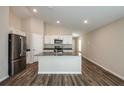 Open-concept kitchen layout with an island sink, stainless steel appliances, and a seamless connection to living area at 762 Ambleside Dr, Haines City, FL 33844