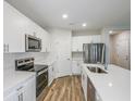 Bright kitchen featuring white cabinets, stainless steel appliances, and hard surface countertops at 3730 King Hill Dr, Haines City, FL 33844