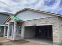 New home under construction showcases concrete walls and framing for the garage and covered porch at 5728 Haystack Drive, St Cloud, FL 34771